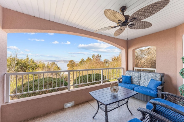 balcony with outdoor lounge area and ceiling fan