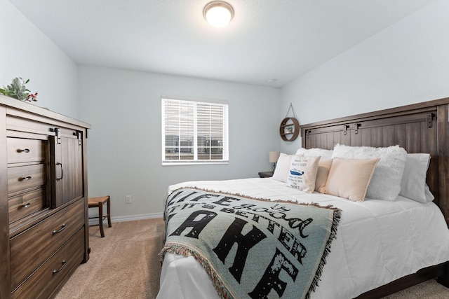 bedroom featuring light carpet and baseboards