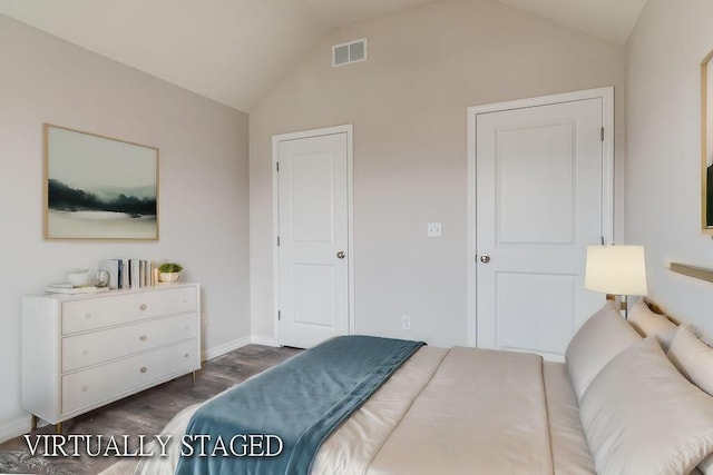 bedroom featuring dark wood-style floors, lofted ceiling, visible vents, and baseboards