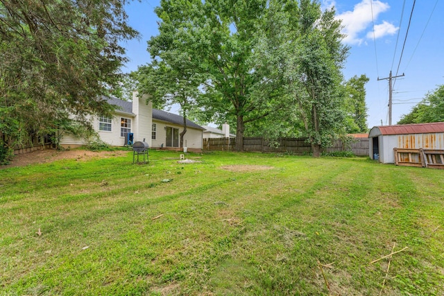 view of yard with a fenced backyard and an outdoor structure