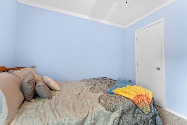 bedroom with crown molding and carpet flooring