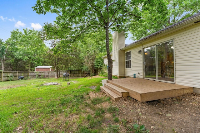 view of yard with fence and a deck