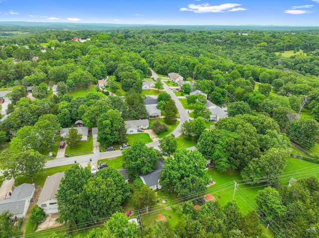 drone / aerial view featuring a residential view and a forest view