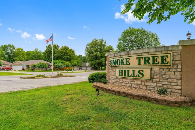 community / neighborhood sign with a yard