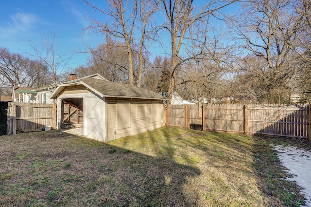 view of yard with an outbuilding, a storage unit, and a fenced backyard