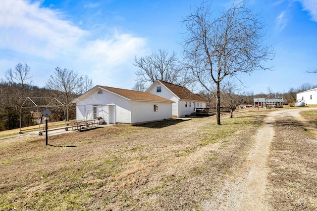 view of side of property with a lawn