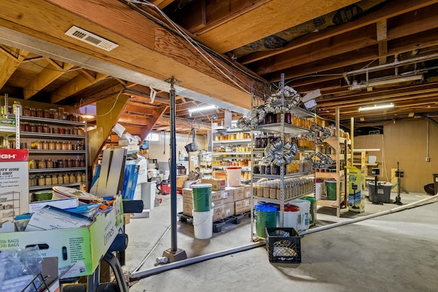 unfinished basement with visible vents and a workshop area