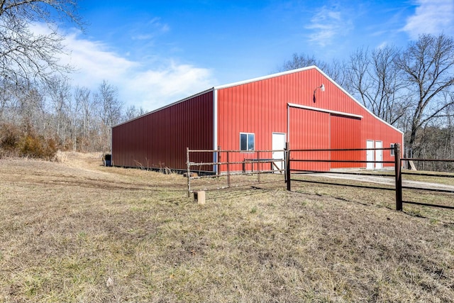 view of pole building featuring fence and a yard