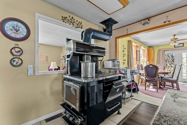 kitchen with french doors, visible vents, ceiling fan, tile patterned flooring, and baseboards