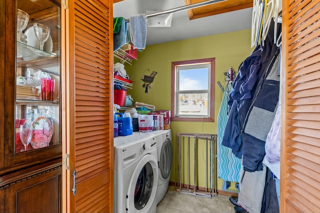 laundry room featuring light tile patterned floors, laundry area, and washer and dryer