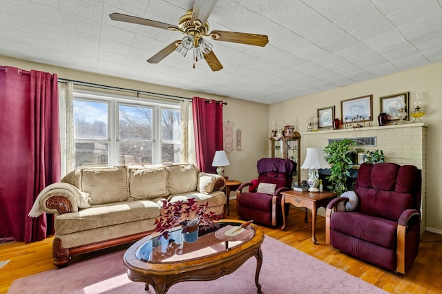 living area featuring a ceiling fan and wood finished floors