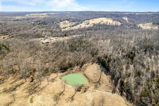 birds eye view of property with a view of trees