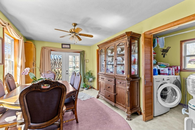 dining area with french doors, washer and clothes dryer, a ceiling fan, and a healthy amount of sunlight