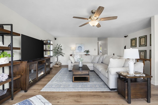 living area featuring a ceiling fan and wood finished floors