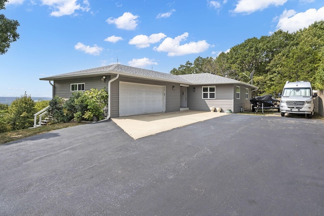 single story home featuring a garage and driveway