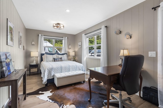 bedroom with light wood-style floors and multiple windows