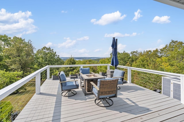 wooden terrace with an outdoor fire pit