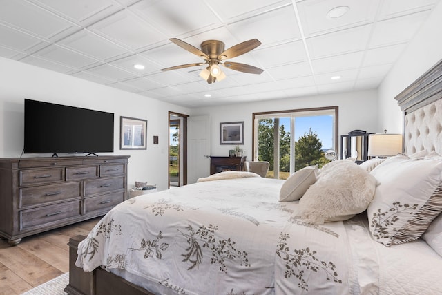 bedroom with access to exterior, light wood-type flooring, a ceiling fan, and recessed lighting