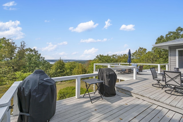 deck featuring outdoor dining area and grilling area