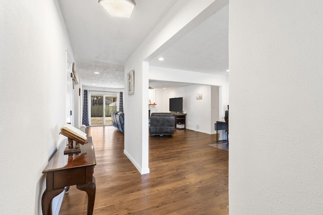 hallway with recessed lighting, baseboards, and wood finished floors