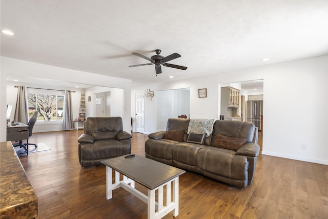 living room featuring baseboards, ceiling fan, wood finished floors, a textured ceiling, and recessed lighting