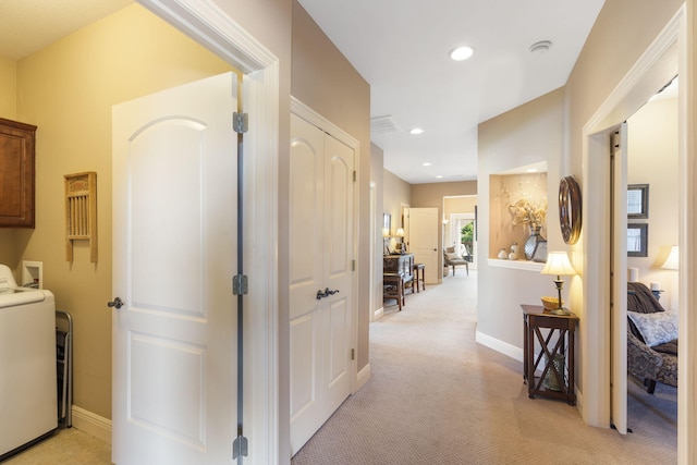 corridor with baseboards, washer / clothes dryer, recessed lighting, and light colored carpet