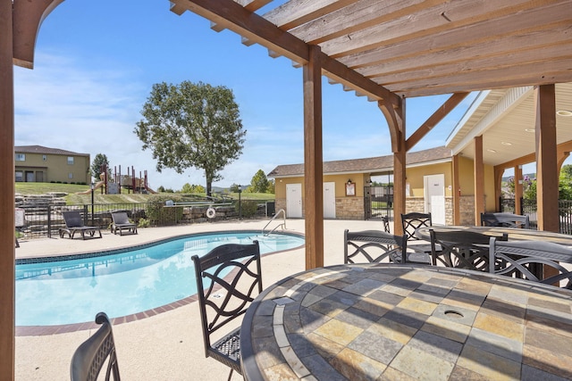 community pool with a patio area, fence, and outdoor dining area