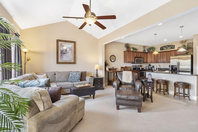 living area featuring a ceiling fan, light colored carpet, vaulted ceiling, and baseboards