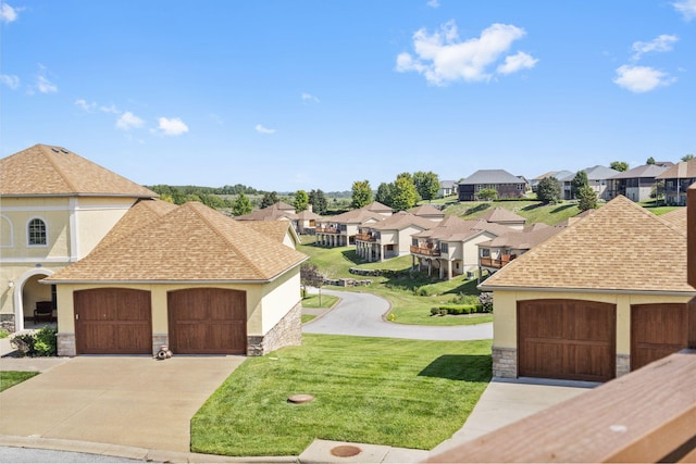 view of front of house with a shingled roof, a residential view, stone siding, and a front yard