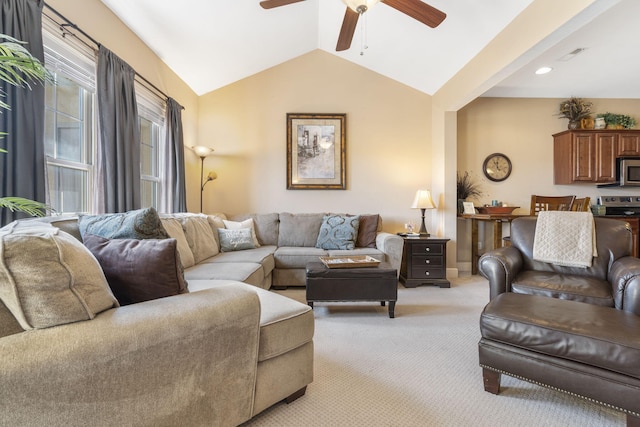 living room featuring light carpet, ceiling fan, lofted ceiling, and baseboards