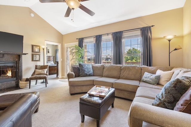 living room with light carpet, ceiling fan, high vaulted ceiling, and a glass covered fireplace