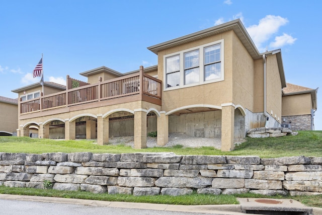 back of house featuring stucco siding