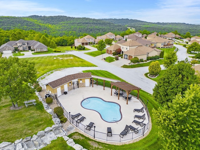 pool with a residential view, a patio area, fence, and a pergola