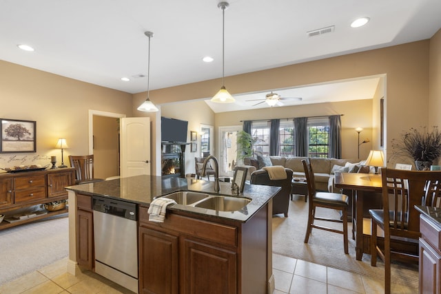 kitchen with a warm lit fireplace, light carpet, a sink, visible vents, and dishwasher