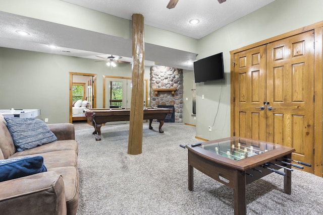 game room featuring pool table, a textured ceiling, a ceiling fan, and carpet flooring