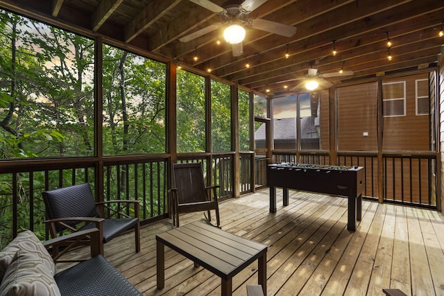 sunroom featuring ceiling fan