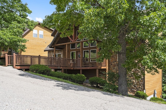 rear view of property featuring a deck