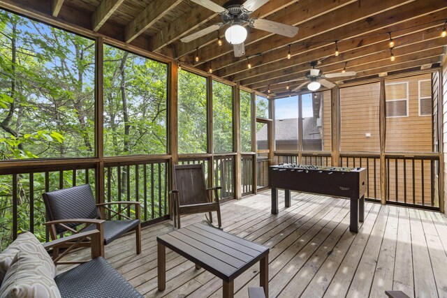 sunroom with a ceiling fan