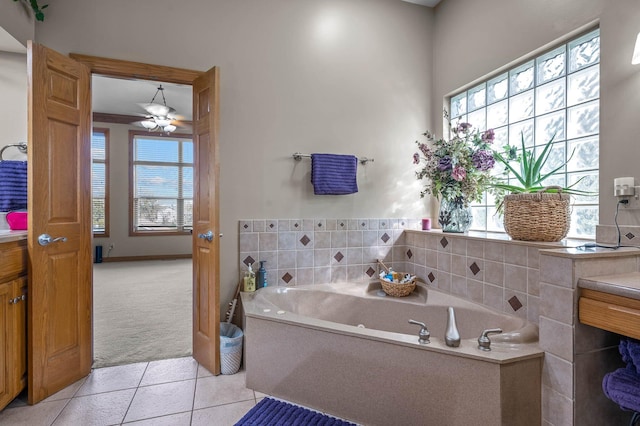 bathroom featuring a garden tub and tile patterned flooring