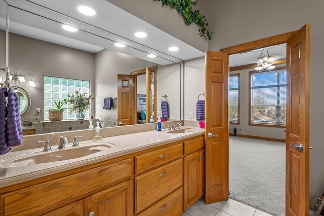 bathroom with tile patterned floors, a sink, recessed lighting, and double vanity