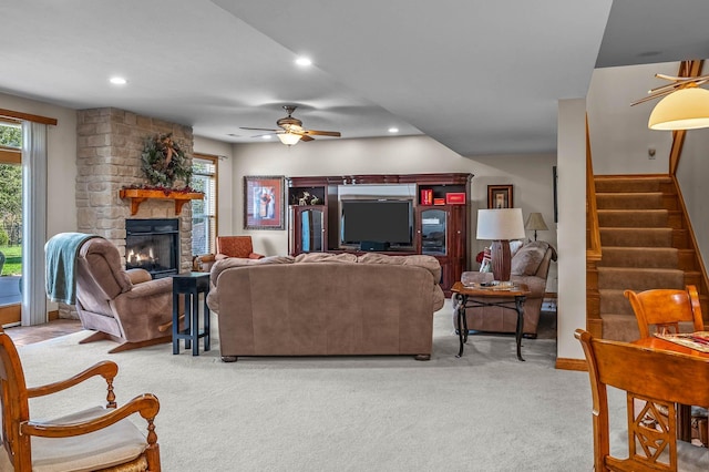 living area featuring a healthy amount of sunlight, light carpet, and a fireplace