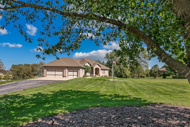 view of front of home with a garage, driveway, and a front lawn