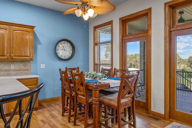 dining space with light wood-style floors, visible vents, plenty of natural light, and baseboards