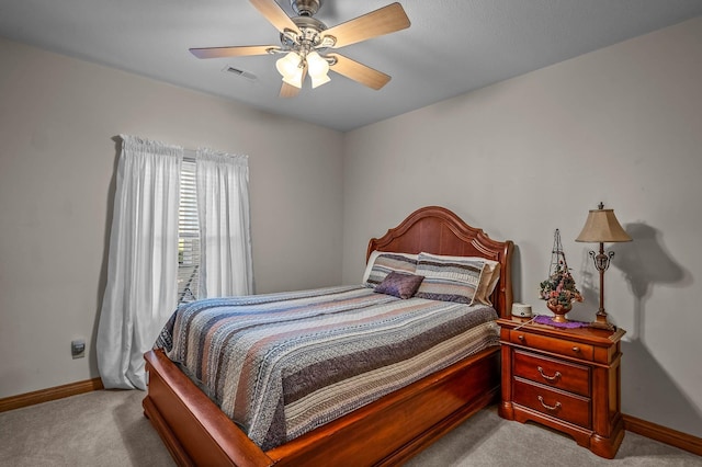 carpeted bedroom with a ceiling fan, visible vents, and baseboards