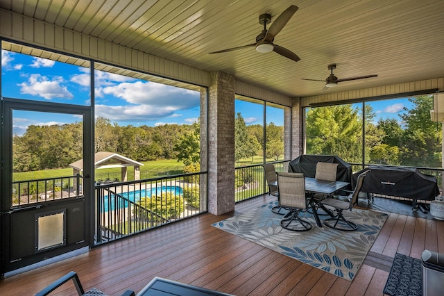 sunroom / solarium with a forest view