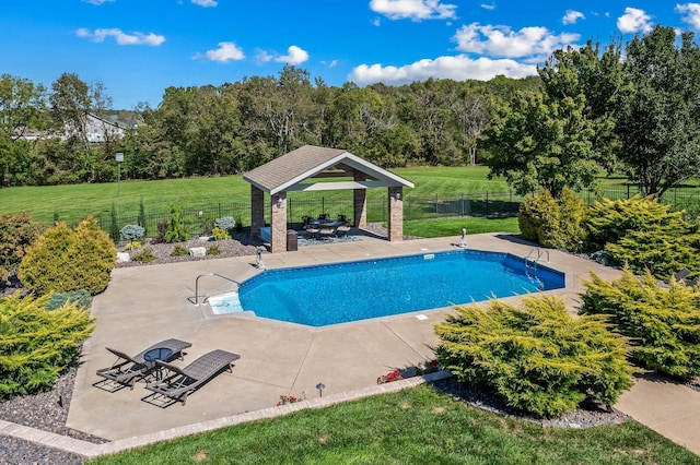 view of pool with a fenced in pool, fence, a lawn, and a gazebo