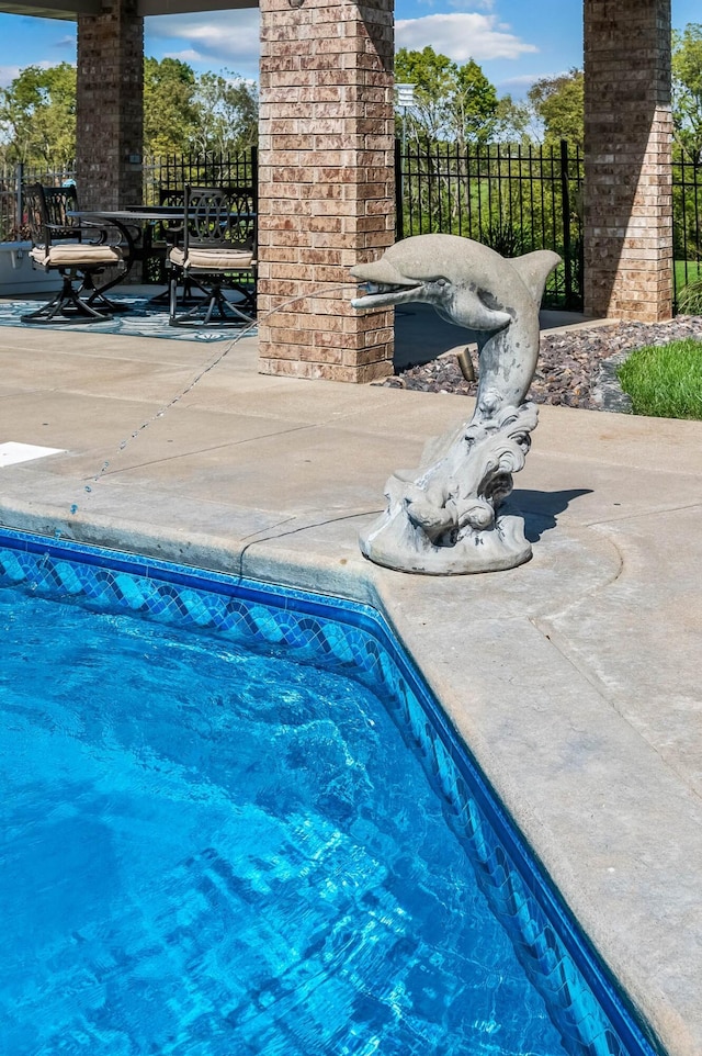 view of swimming pool with fence and a patio