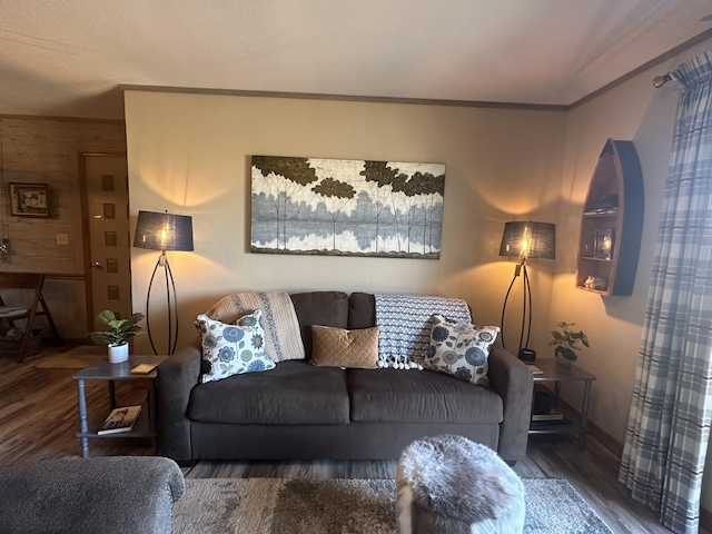 living room with wood finished floors and crown molding