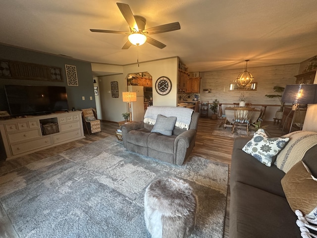 living room with ceiling fan and wood finished floors