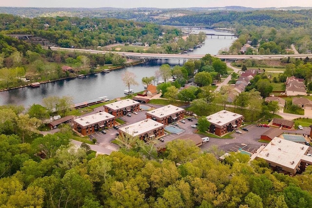 birds eye view of property with a water view and a view of trees